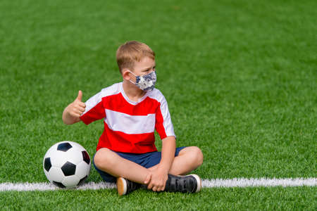 Football soccer training for kids. Boy running and kicking soccer ball. Young boy improving soccer skillsの写真素材