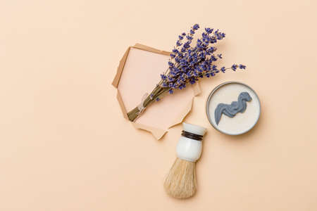Shaving brush, dried lavender and shaving foam on camel color background. Spa organic foam. Zero waste conceptの写真素材