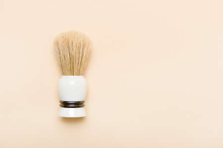 Shaving brush, dried lavender and shaving foam on camel color background. Spa organic foam. Zero waste conceptの写真素材