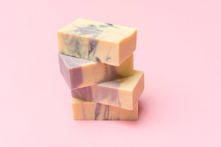 Hand made soap bars on pink color background, top view. Space for text. Zero waste concept