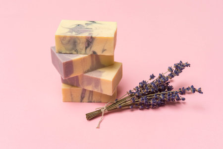Natural handmade soap with dried lavender and essential oil on pink background. Zero waste concept