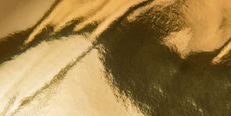Gold foil texture background. Gold texture and gradients shadow.の写真素材