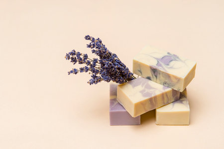 Natural handmade soap with dried lavender and essential oil on pink background. Zero waste concept