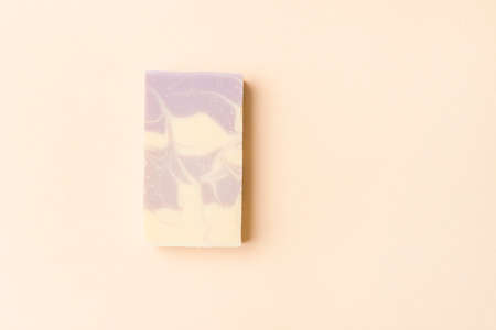 Hand made soap bar on camel color background, top view. Space for text. Zero waste conceptの写真素材