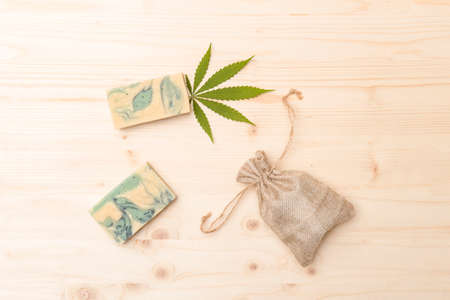 Homemade hemp soap, bag and green leaf of marijuana. Spa organic soap. Organic skincare product with medicinal CBD. Zero waste conceptの写真素材