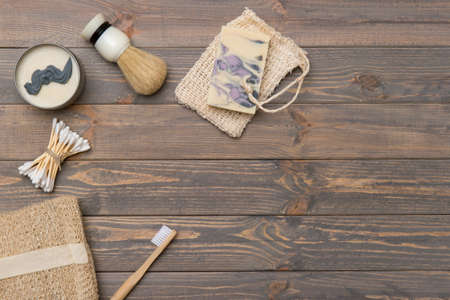 Flat lay shaving tools and bathroom accessories for man on wooden background. Zero waste concept.の写真素材