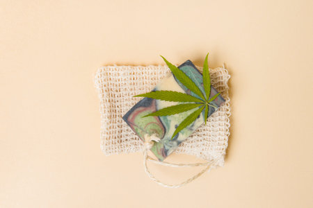 Homemade hemp soap and green leaf of marijuana. Spa organic soap. Organic skincare product with medicinal CBD. Zero waste conceptの写真素材