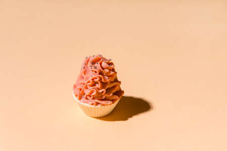 Natural handmade soap, cupcake with cream on cream color background. Zero waste, eco friendly cosmetics concept.の写真素材