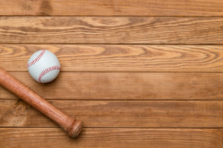 Baseball bat and ball on wooden background. Sport theme background with copy space for text and...