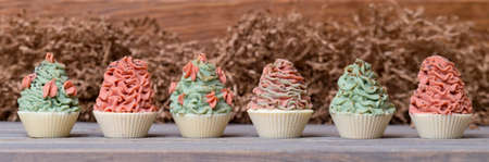 Natural handmade soaps, cupcakes with cream on woden table. Zero waste, eco friendly cosmetics concept.の写真素材