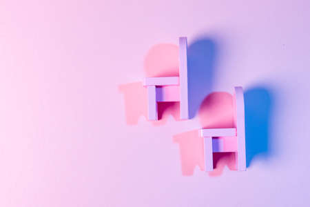 Empty Chairs Against Pink Backgroundの写真素材