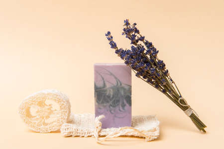 Natural handmade soap with dried lavender and essential oil on camel color background. Zero waste conceptの写真素材