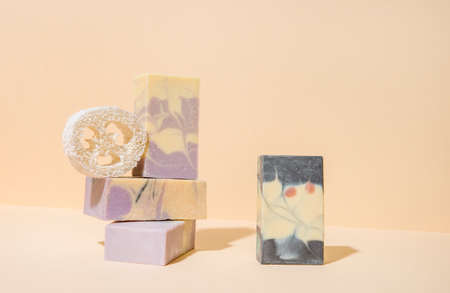 Handmade soap and loofah sponge on a cream color background. Zero waste, eco friendly cosmetics concept. Eco lifestyle theme.の写真素材