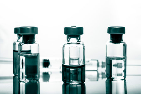 Medical concept Vaccination vaccine vial dose flu shot drug needle syringe. Green color filterの写真素材