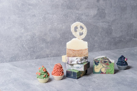 Handmade soaps and loofah sponges on grey background. Eco lifestyle concept.の写真素材