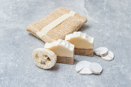 iHandmade soap and loofah sponges on grey background. Eco lifestyle concept.の写真素材