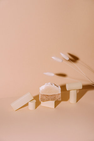 Handmade soap, loofah sponge and geometric shapes.  Sunshade shadow on beige background. Zero waste, eco friendly cosmetics concept. Eco lifestyle theme.の写真素材