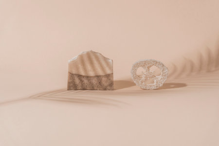 Handmade soap and loofah sponge.  Sunshade shadow on beige background. Zero waste, eco friendly cosmetics concept. Eco lifestyle theme.の写真素材