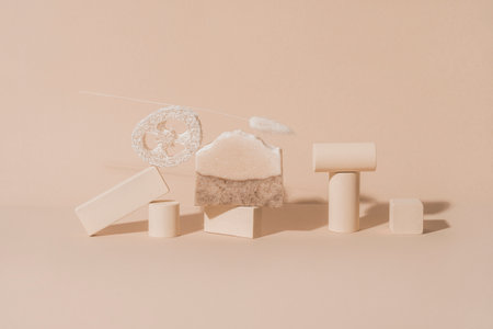 Handmade soap, loofah sponge and geometric shapes.  Sunshade shadow on beige background. Zero waste, eco friendly cosmetics concept. Eco lifestyle theme.の写真素材