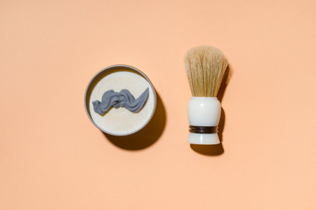 Shaving brush and shaving foam on camel color background. Spa organic foam. Zero waste conceptの写真素材