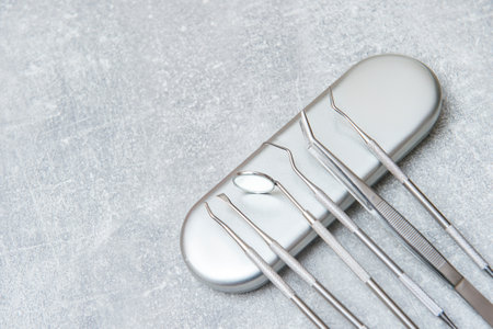 Dentist tools and mask on grey background. Dental banner or backgroundの写真素材