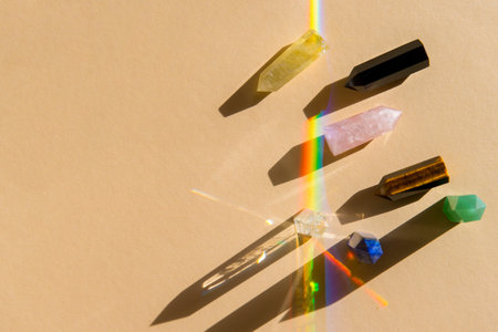 Healing chakra crystals with rainbow on beige
