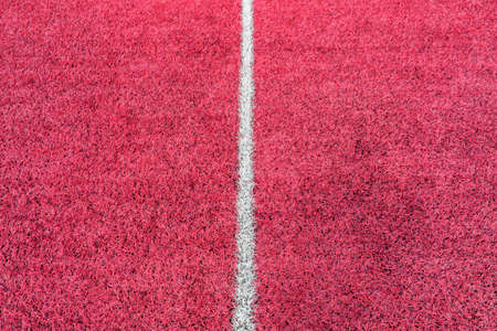 Pink synthetic grass sports field with white line shot from above. Soccer, rugby, football, baseball sport conceptの写真素材