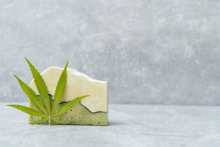 Homemade hemp soap and green leaf of marijuana. Spa organic soap. Organic skincare product with medicinal CBD. Zero waste conceptの写真素材
