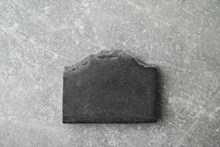 Soap bar handmade from natural charcoal on grey background