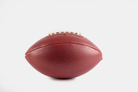 Leather american football on white background. Sports background for product display, banner, or mockupの写真素材