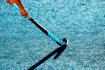 Battle for control of ball during field hockey game. Vintage color filterの写真素材