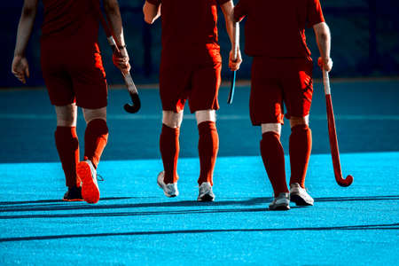 Three Field hockey players on the grass background. Vintage color filterの写真素材