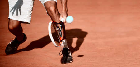 The tennis player puts the ball. Vintage color filterの写真素材