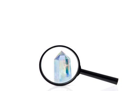 High angle view of magnifying glass with natural clear crystal quartz electroplating rainbowの写真素材