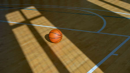 Basketball on hardwood court floor with natural lighting. Workout online conceptの写真素材