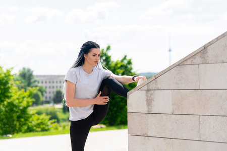 Fitness sport woman with african braids doing stretching exercise in the park