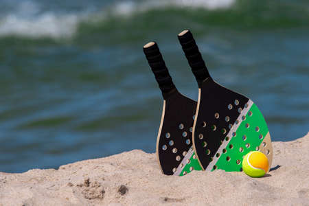 Rackets and ball on the sandy beach. Summer sport conceptの写真素材