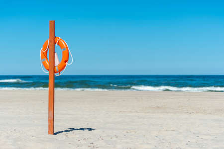 Life buoy preserver on sandy beach somewhereの写真素材