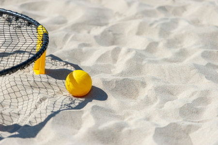 Spike ball game with yellow ball on sand. Summer game conceptの写真素材