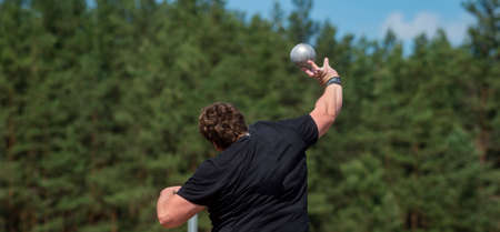Sportsman practising shot put. Professional sport concept. Horizontal sport poster, greeting cards, headers, websiteの写真素材