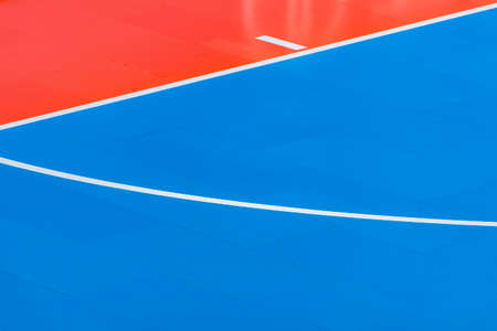 Blue and orange floor volleyball, basketball, badminton, futsal, handball court. Wooden floor of sports hall with marking lines line on wooden floor indoor, gym courtの写真素材