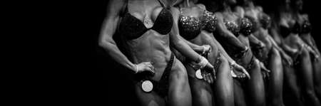group woman athletes bodybuilders posing most muscular bikini fitness competitions. Black and white filter. Horizontal sport poster, greeting cards, headers, website.の写真素材