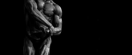 Bodybuilder posing. Beautiful sporty guy male power. Fitness muscled man. Black and white color filter. Horizontal sport poster, greeting cards, headers, websiteの写真素材