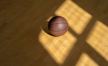 Basketball court wooden floor with professional brown leather ball and shadows. Horizontal sport poster, greeting cards, headers, websiteの写真素材