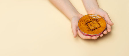 Korean dalgona honeycomb sugar cookie with square shapes .Hands play new trend candy challengeの写真素材