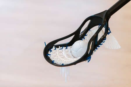 Lacrosse stick and white ball on cream background. Horizontal sport theme poster, greeting cards, headers, website and appの写真素材