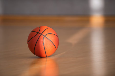Basketball on hardwood court floor with natural lighting. Workout online concept, Horizontal sport theme poster, greeting cards, headers, website and app