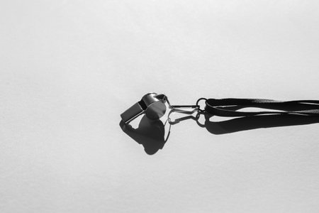 Sports whistle on grey background. Concept - sport competition, referee, statistics, challenge. Basketball, handball, futsal, volleyball, soccer, baseball, football and hockey referee whistleの写真素材