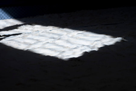 The shadow from the window on sand volleyball court