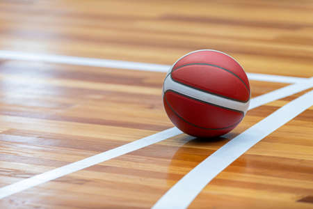Basketball court wooden floor with professional orange leather ball and shadows. Horizontal sport poster, greeting cards, headers, websiteの写真素材
